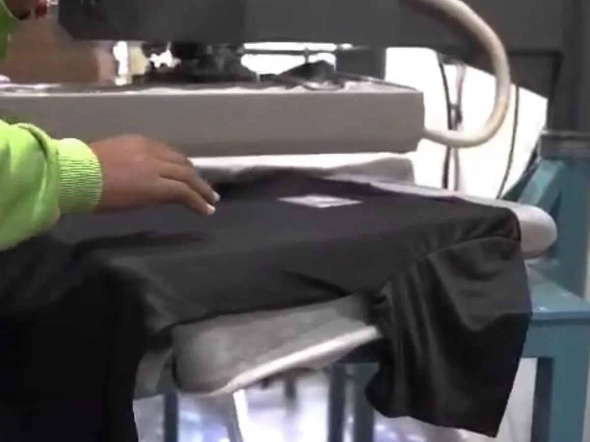 Heat press applying a transfer to a garment