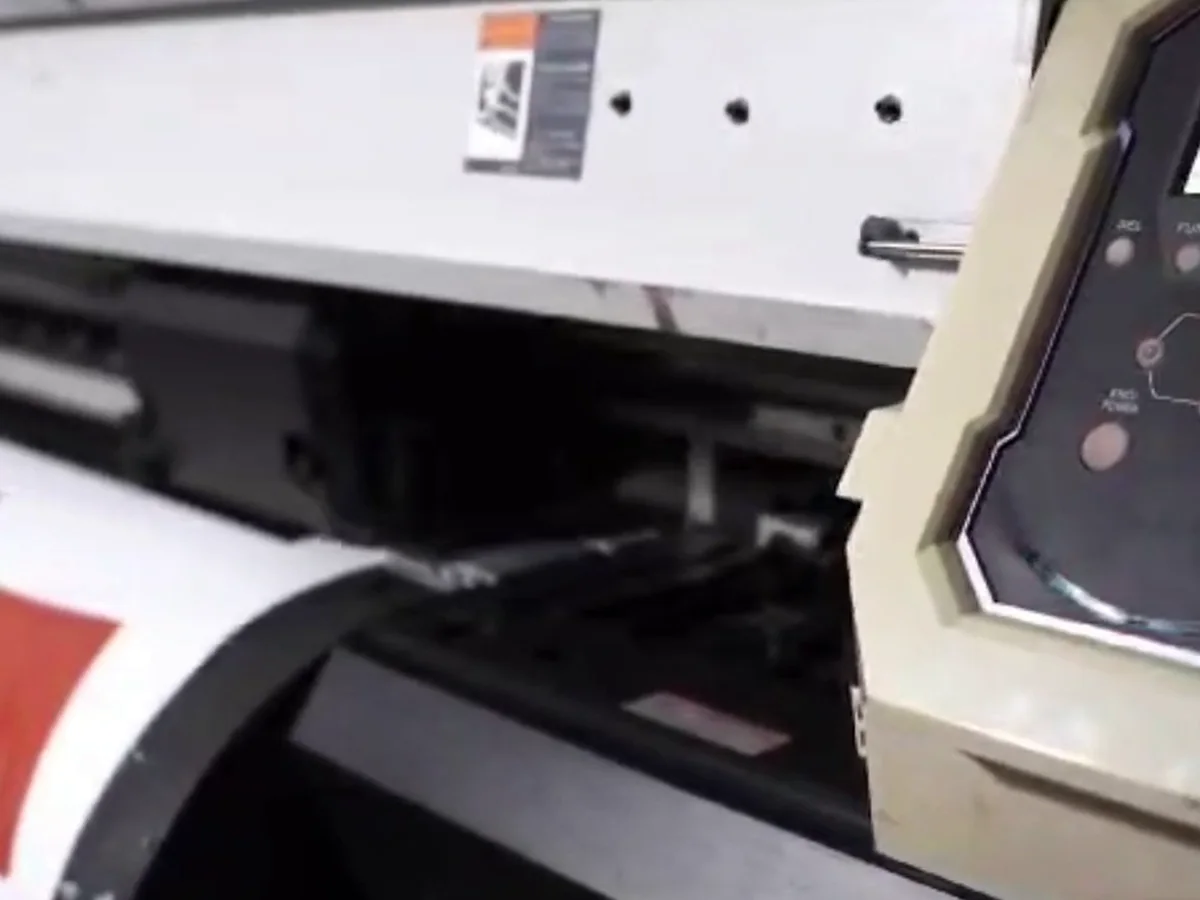 Large-format sublimation printer running printed garment panels