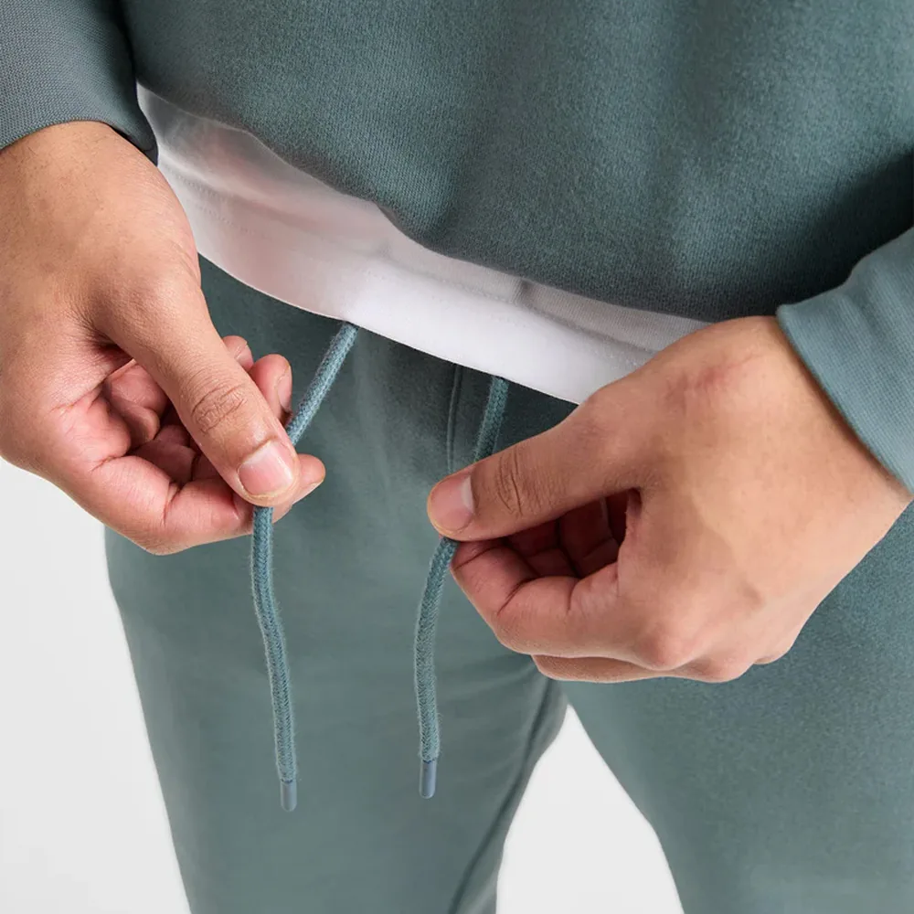 Drawcord and eyelet detail at the waistband of fleece joggers